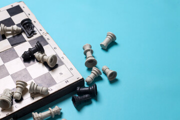 Top view of chess board with figures on blue background with copy space. Business strategy and teamwork concept © Queenmoonlite Studio