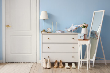 Interior of stylish hall with drawers and mirror