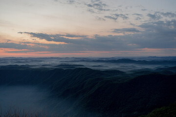 View of the sunset in the mountains with a lot of fog