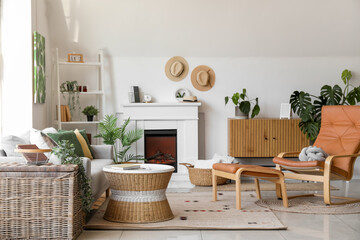 Interior of cozy living room with sofa, armchair and fireplace