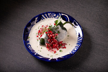 Chiles en Nogada, Typical dish from Mexico. Prepared with poblano chili stuffed with meat and fruits and covered with a walnut sauce. Named as the quintessential Mexican dish for national holidays.