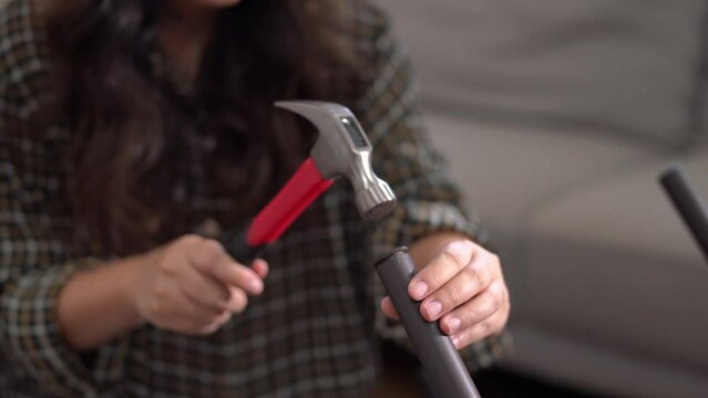 women adjusting or repair assembling chair Furniture at home diy concept.