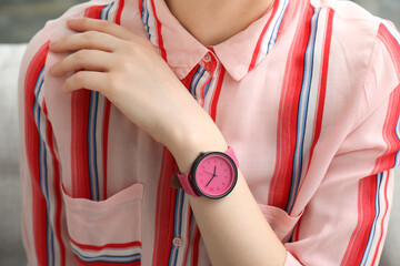 Young woman with stylish wristwatch in room, closeup