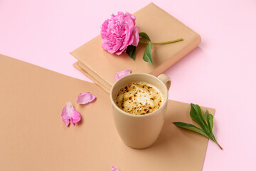 Composition with cup of coffee, book and peony flower on color background