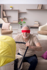Old man looking after newborn at home