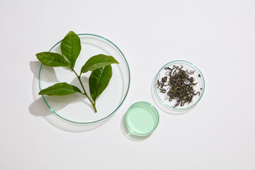 Scene for advertising cosmetic product with green tea ingredient with white background. Petri dish...