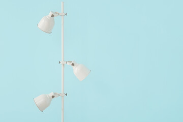 Standard lamp near blue wall