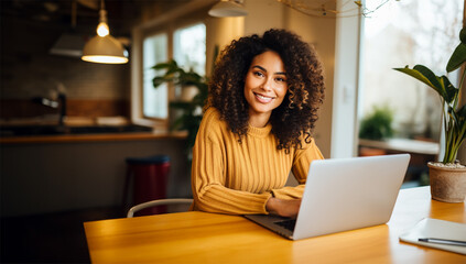 a beautiful ethnic woman working remotely on her laptop from home