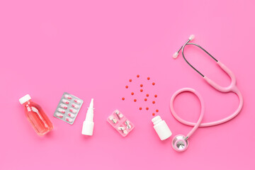 Fototapeta premium Stethoscope, pills and nasal spray on pink background