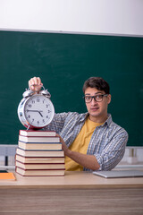 Young male student in time management concept