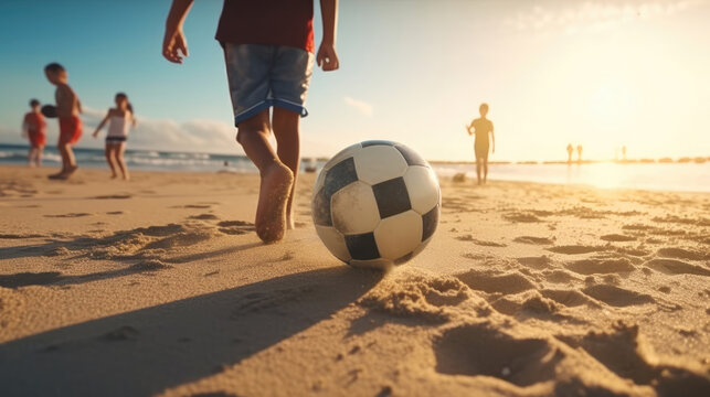 A young boy kicking a ball, people playing football on the beach