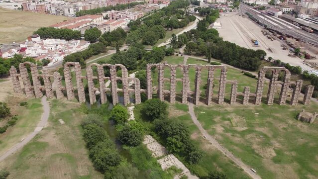 Los Milagros aqueduct or aqueduct of miracles aerial view rising away from ancient ruin brick pillars in M&eacute;rida, Spain