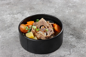 Sop Buntut or Sup Buntut is Indonesian Oxtail Soup with Carrot, Potato and Spring Onions.
