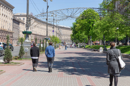 pedestrians walking on the side walk in capital kyiv