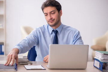 Young male employee working in the office