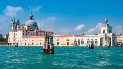 Fototapeta na wymiar Venice, Italy. Panoramic view over Grand Canal and Basilica di Santa Maria della Salute and the historical center at sunny day and blue sky.