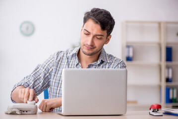 Young male employee working in the office