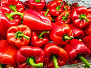 Pile of Red bell peppers in a supermarket local market, Bunch of organic red peppers. Fresh ripe red peppers	