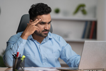 Worried indian Businessman or entrepreneur after seeing mail on laptop at office - concept of work...