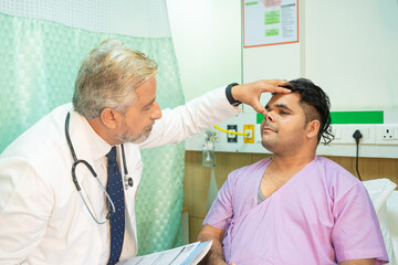 Doctor checking patient at hospital.