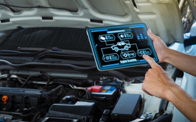 Smart Car Service Diagnostics Software concept.Mechanic using digital tablet Inspecting the Vehicle