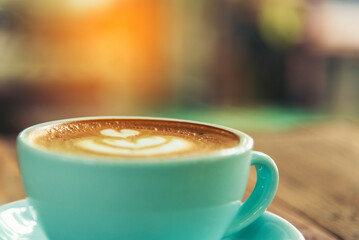 Latte art coffee cup with milk on wooden table. Espresso shot make latte art hot coffee cup. Cappuccino with milk in italian coffee shop cafe. Brown hot caffeine beverage in cafeteria with copy space