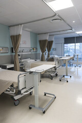 General view of patient room with beds and medical equipment at hospital