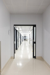 General view of corridor with white walls and floor at hospital
