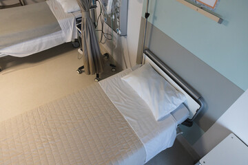 Close up of beds and medical equipment in patient room at hospital