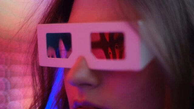 Young woman with retro 3d glasses by the neon lights