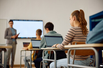 Fototapeta premium High school student and her classmates attending computer class in classroom.