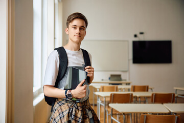 Portrait of high school student in classroom looking at camera.
