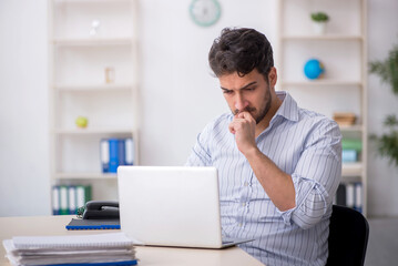 Young male employee working in the office