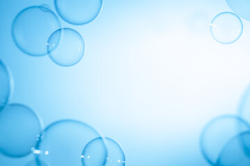 Abstract Fun Background, Beautiful Transparent Shiny Blue Soap Bubbles Floating in The Air. Blank White Space, Blue Gradient Blurred Background, Refreshing of Soap Suds Bubbles Water.