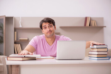 Young male student preparing for exams at home