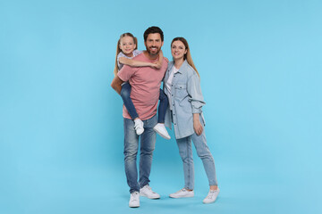 Fototapeta premium Happy family together on light blue background