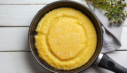 basic polenta in pan on white wooden table, authentic italian recipe, view from above