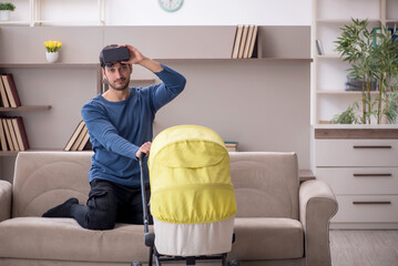 Young male contractor looking after baby at home