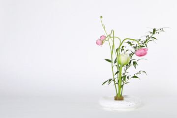 Beautiful ikebana for stylish house decor. Floral composition with fresh flowers and branches on white background, space for text
