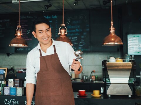 Cheerful Asian Man Making A Coffee Cup In Cafe,Barista Prepares Coffee For The First 