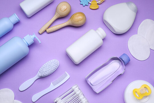 Flat lay composition with baby care products and accessories on lilac background