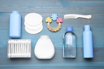 Flat lay composition with baby care products on light blue wooden table