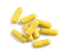 Many yellow pills isolated on white, top view