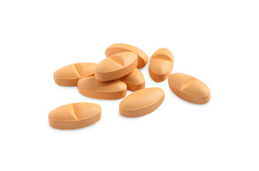 Many orange pills isolated on white. Medicinal treatment