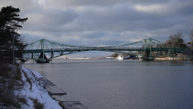 Green metal bridge (Karostas tilts) over canal in winter in Liepaja