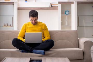 Young male freelancer working from home during pandemic