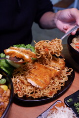 person holding a bowl of noodles