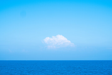 Huge white fluffy clouds sky background with blue sky background over ocean