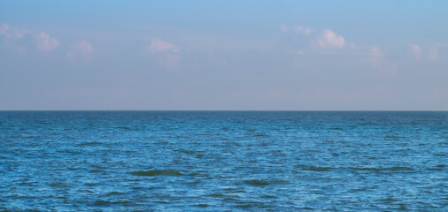 Obraz premium Blue Sea Ocean under blue sky with fluffy white cloud seascape nature background summer travel vacation