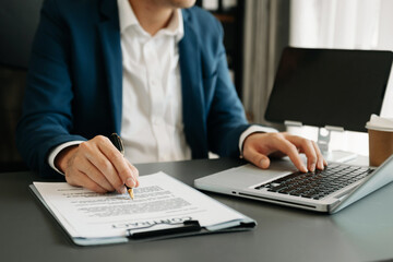 business documents on office table with smart phone and digital tablet and graph financial and woman working at office.